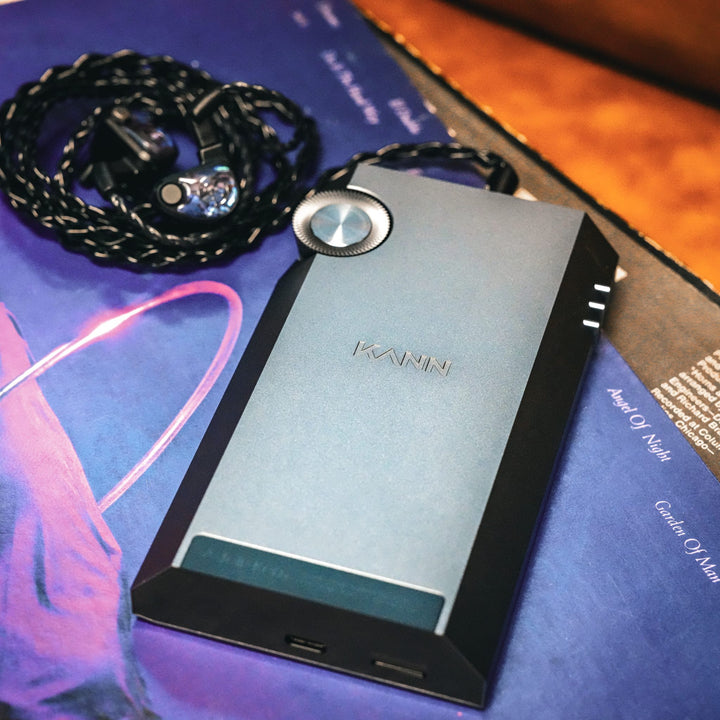 Astell&amp;Kern KANN Ultra rear over purple vinyl record with connected earphones