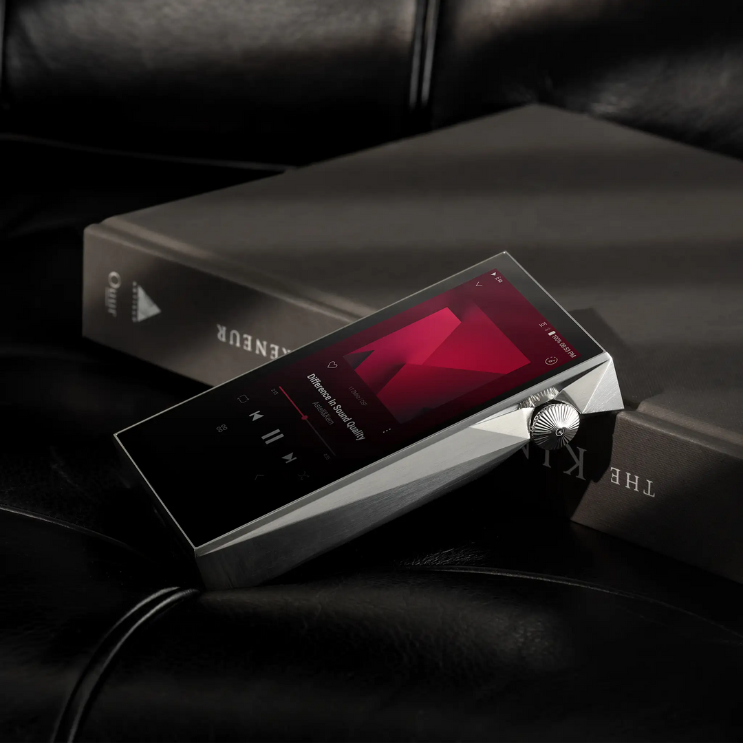 Astell&amp;Kern SP3000M Copper Nickel leaning on book on black leather couch