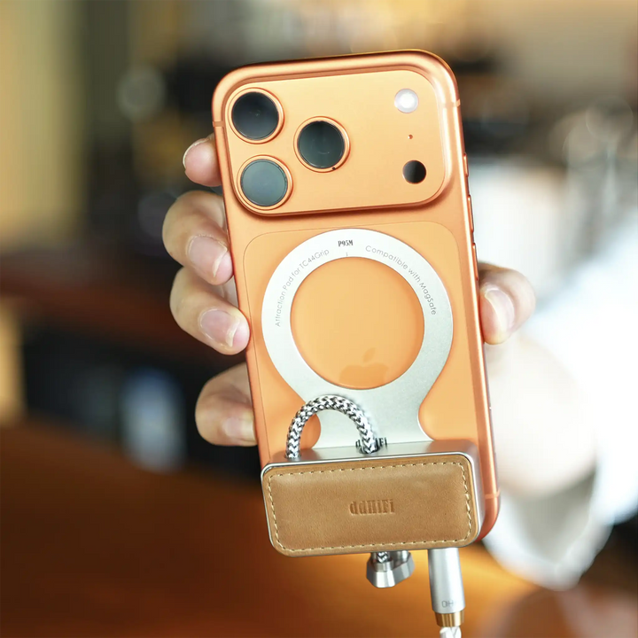 ddHiFi P95M attraction pad attached to back of vertical iPhone with TC44Grip held in a person&