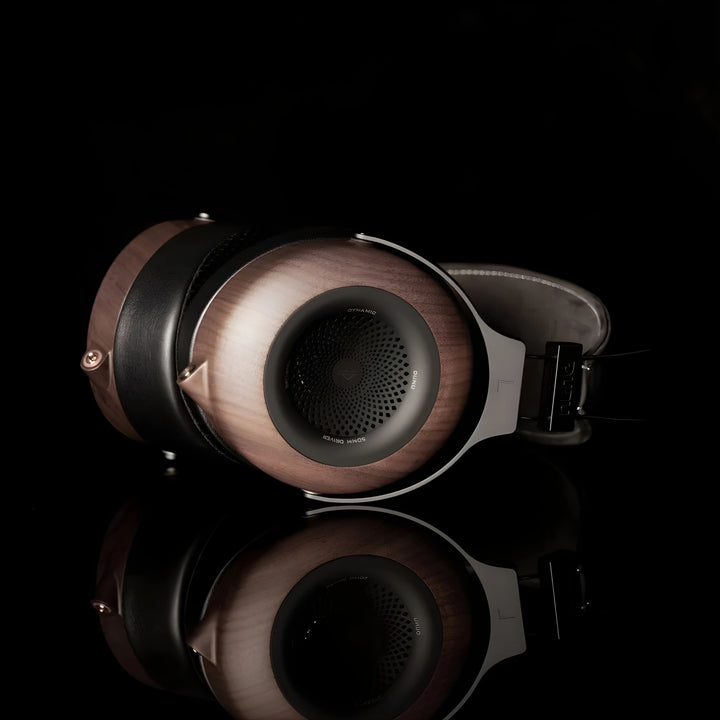 DUNU Mortise headphones lying on side left ear cup view black background