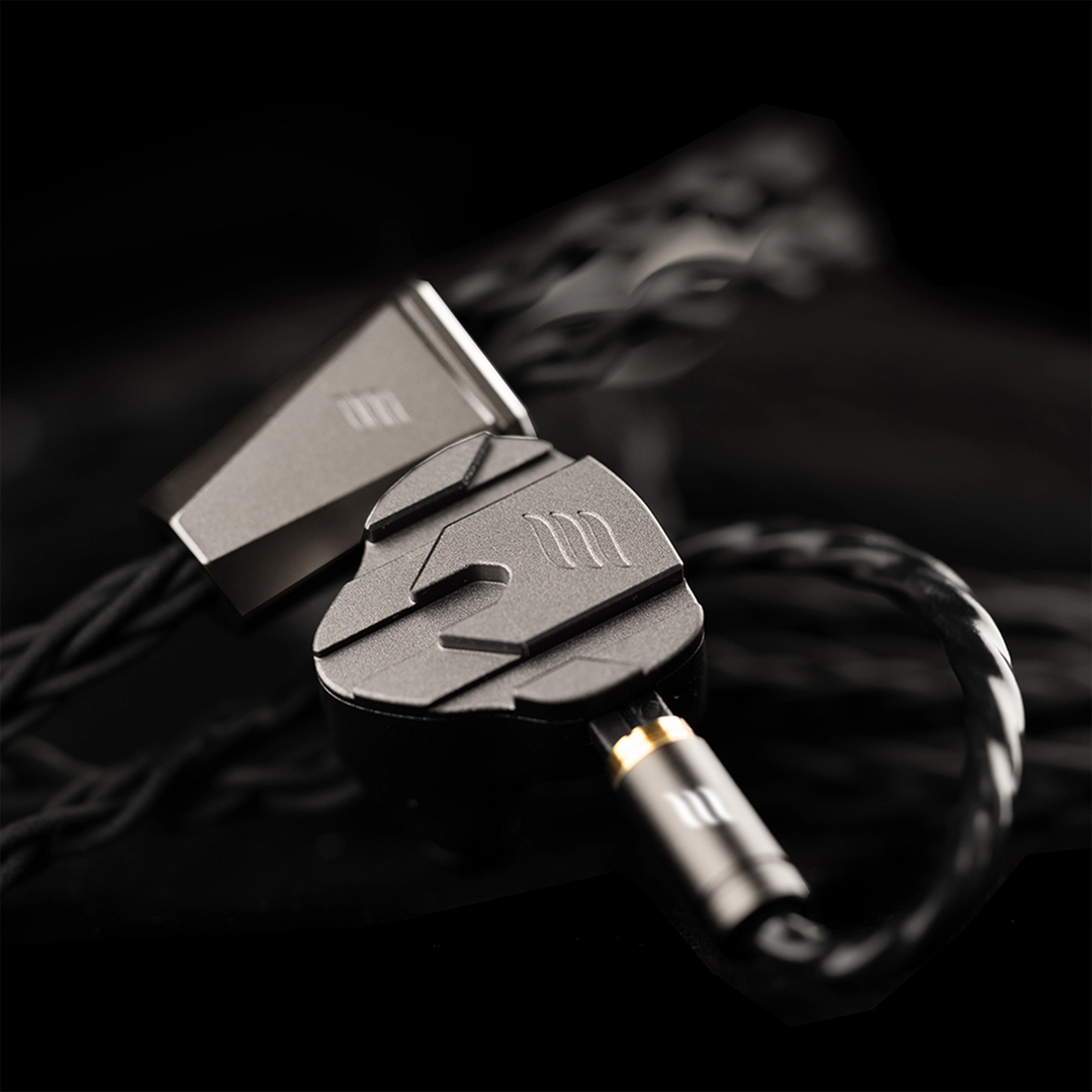 Close-up of a effect audio perseus iem with a focus on the connector against a dark background.