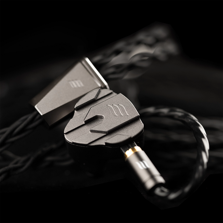 Close-up of a effect audio perseus iem with a focus on the connector against a dark background.