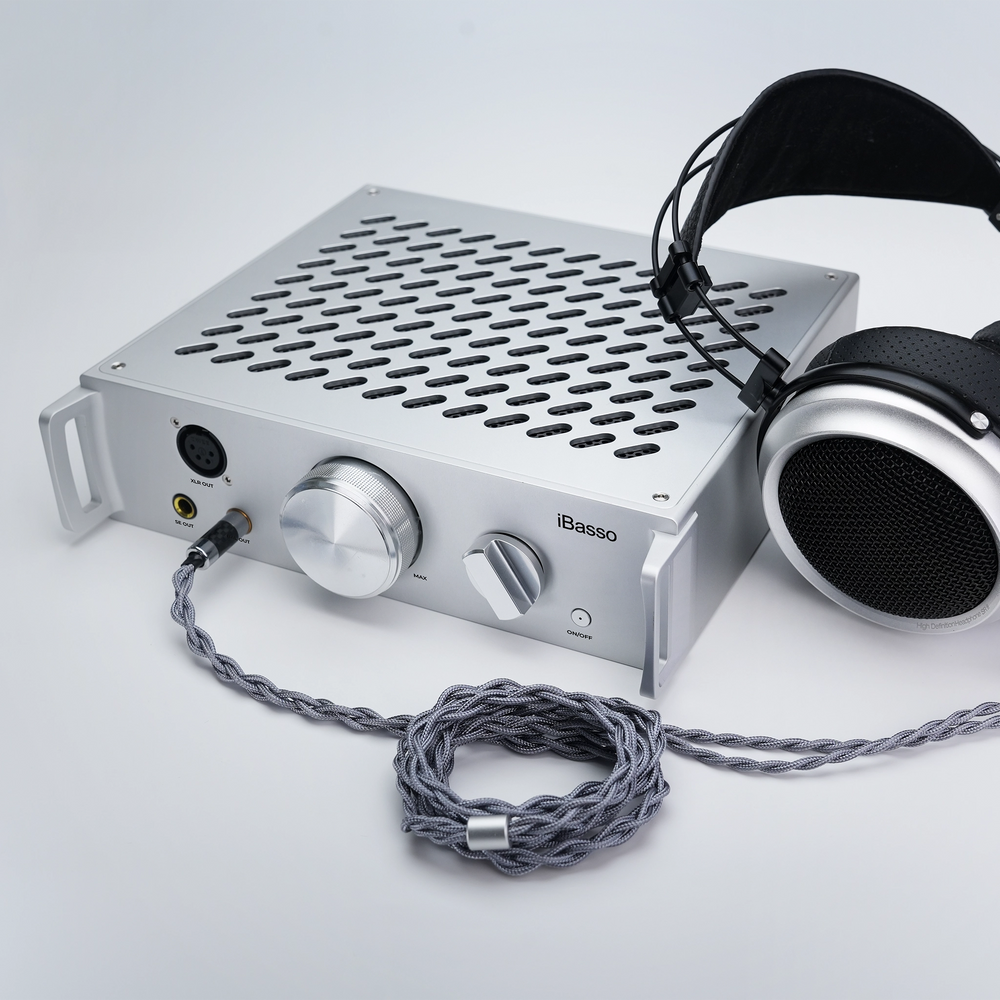 iBasso Kunlun desktop amplifier sitting front right 3 quarter with iBasso SR3 headphone plugged in whitebox