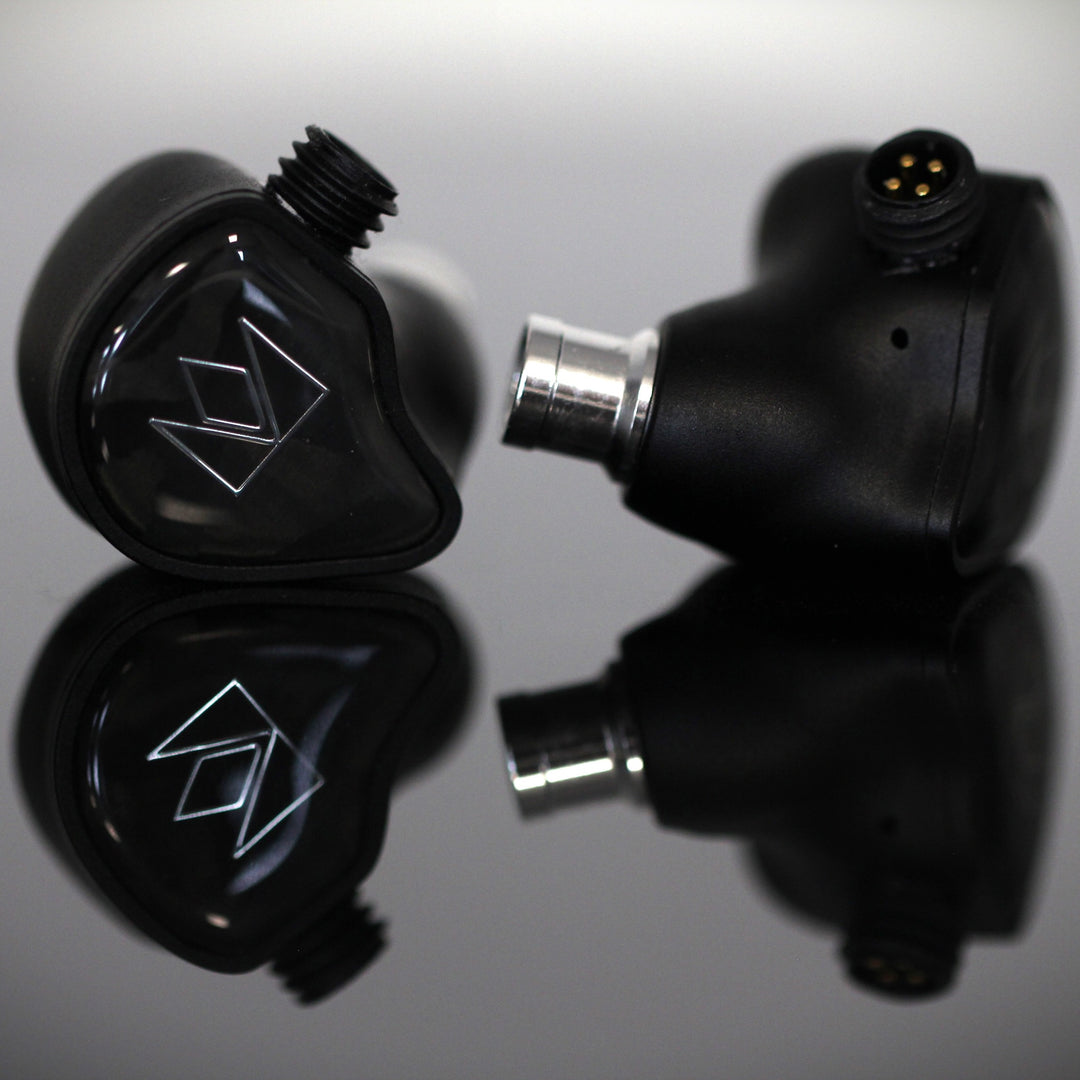 Noble Audio XM-1 front and profile closeup over gray reflective background