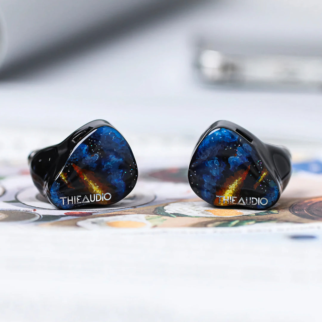 ThieAudio Origin earphones eye level front shells over painting 