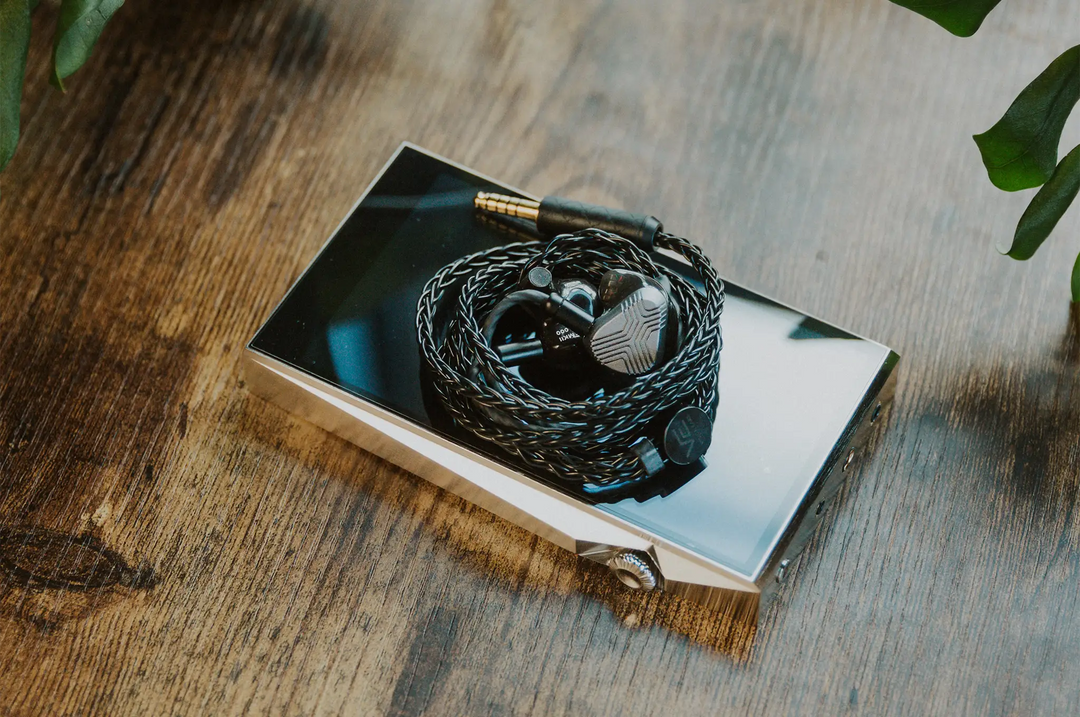 Vision Ears EXT MKII IEMs coiled in cable sitting on Astell&amp;kern DAP on wooden table