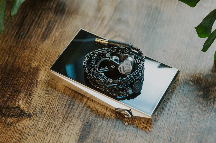Vision Ears EXT MKII IEMs coiled in cable sitting on Astell&amp;kern DAP on wooden table