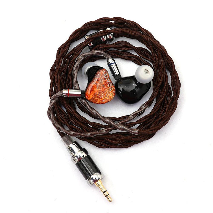 Thieaudio Monarch MKII with attached coiled cable and eartips over white background